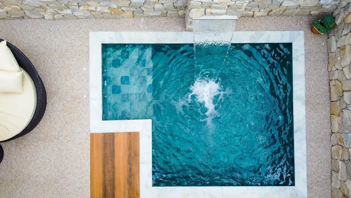 Piscina com cascata e revestimento em tons de azul